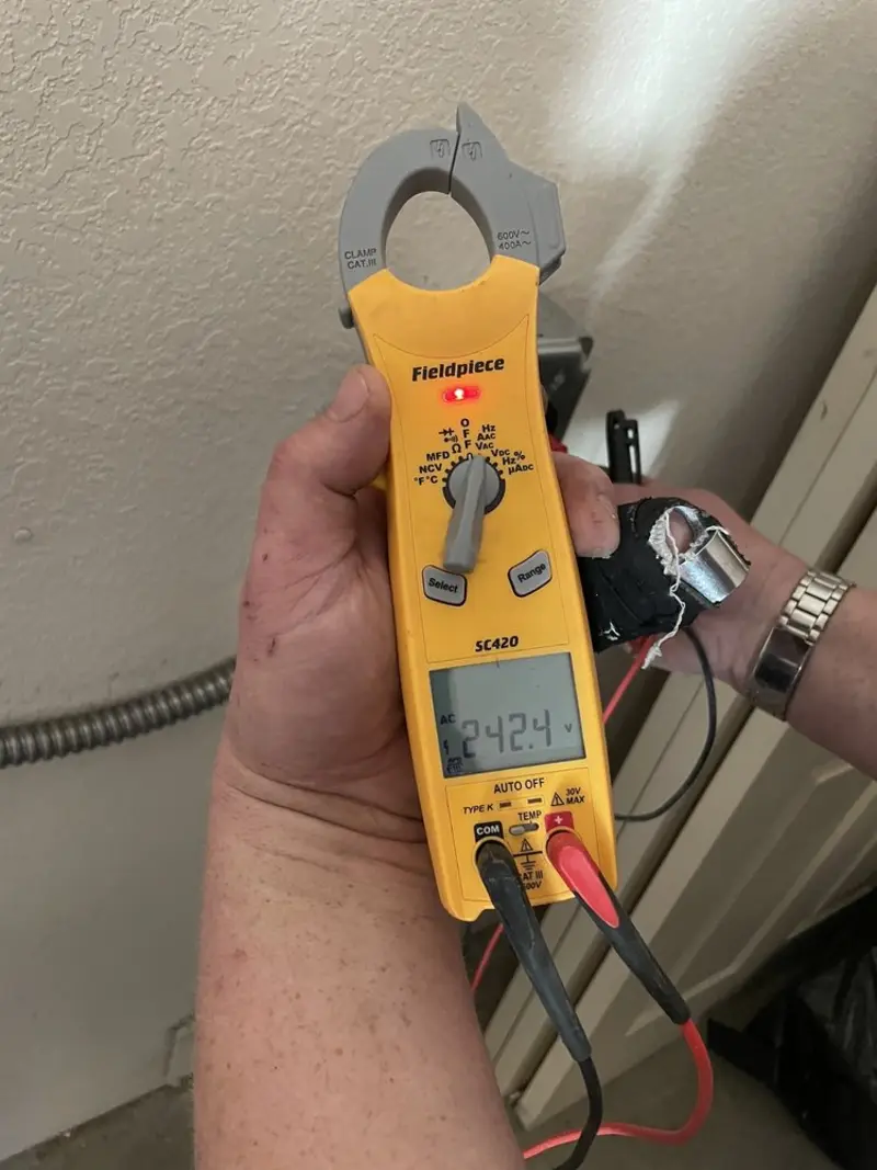 Voltage testing with clamp meter during Outlet Installation in Mosinee